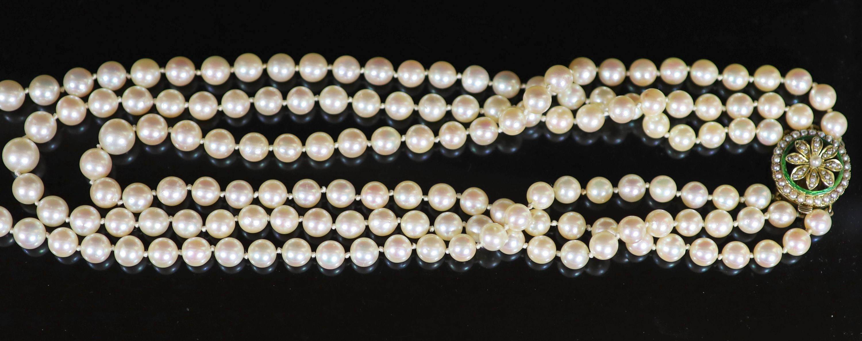 A mid 20th century triple strand cultured pearl choker necklace, with gold, seed pearl and enamel set circular clasp